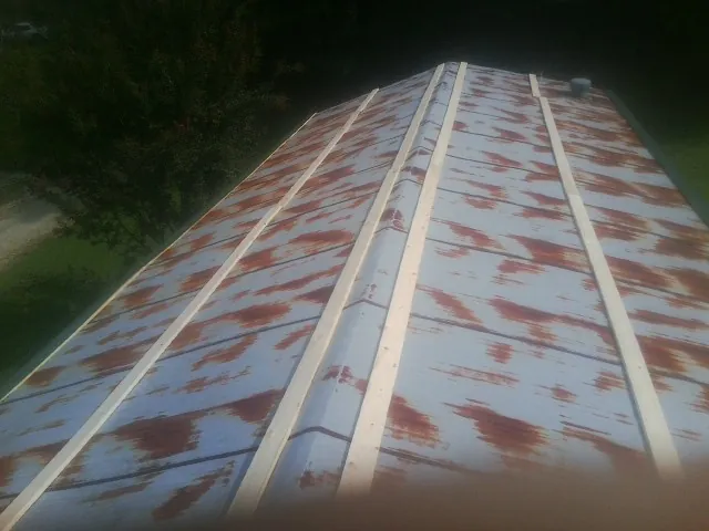 Rusted metal roof panels with new wood purlins before replacement — Storm Damage Roof Repair in Blencoe by Roofing Brothers